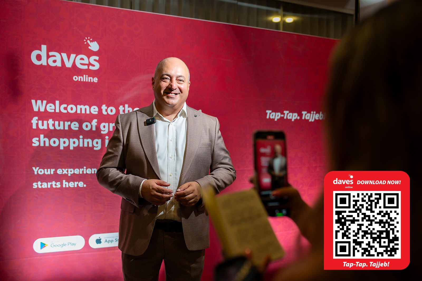 The daves app launch event, with a download QR code for the app.